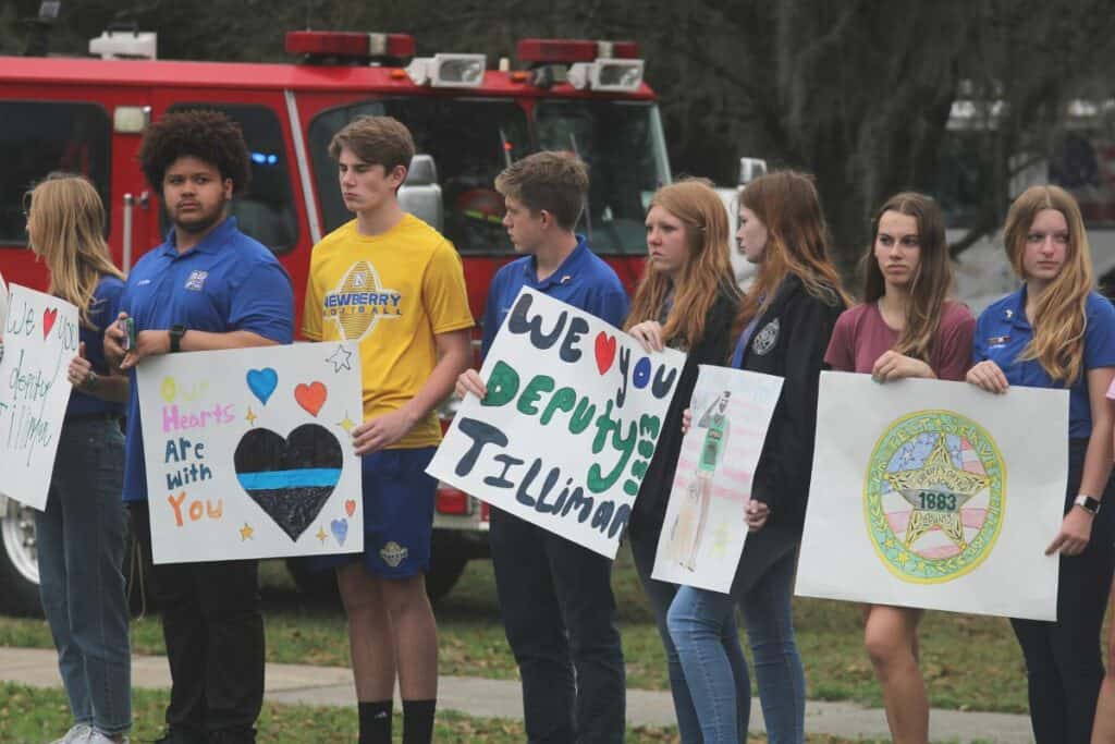 Newberry students lined the State Road 26 on Friday with signs honoring Alachua County Sheriff's deputy Nikolas Tilliman who died on Wednesday.