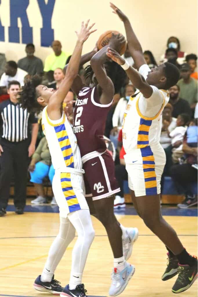 Newberry's Bryan Eastman (2) and Dylan Strappy defend against Madison County's Labron Lee in the Region 3-1A semifinals on Thursday.