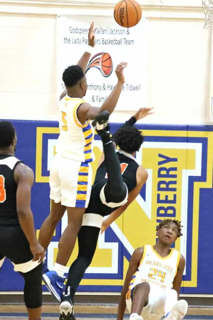 Newberry's Juwan Scippio (24) draws an offensive charge from Hawthorne's Leland Johnson in the District 1A-6 championship game on Friday.