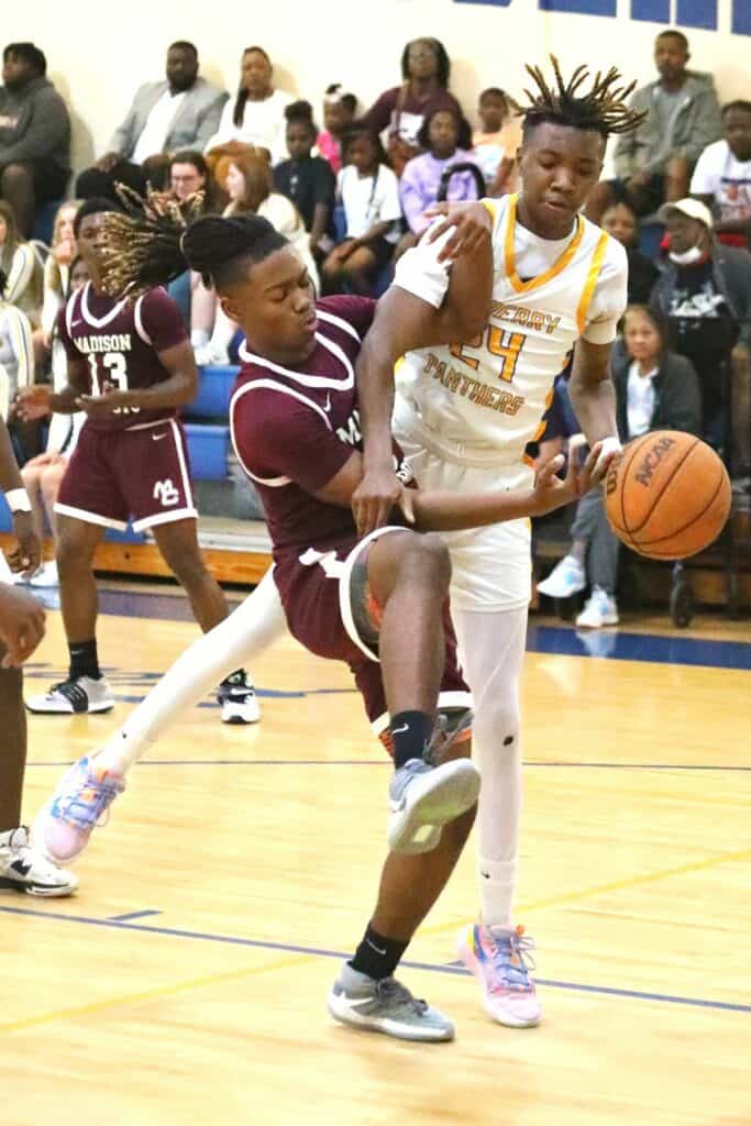 Newberry's Juwan Scippio swats away the ball from Madison County's Oshea Akins in the Region 3-1A semifinals on Thursday.