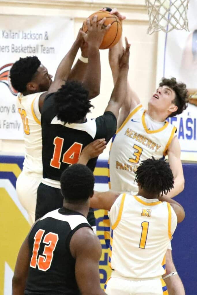 Newberry's Logan McCloud (10) and Mason Smith (3) battle Hawthorne's Demetrius Brown (14) for a rebound in the District 1A-6 championship game on Friday.