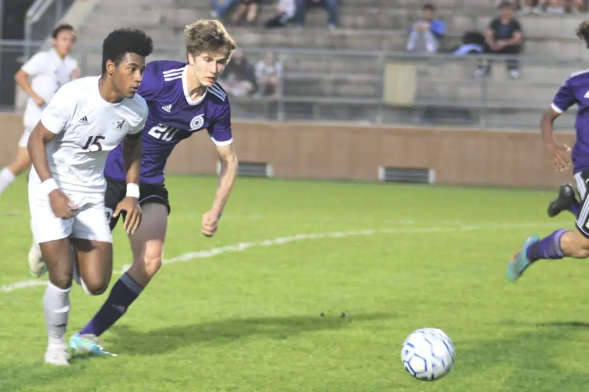 Niceville's Ayden Morales and Gainesville's Donovan Woodend rush to the ball.