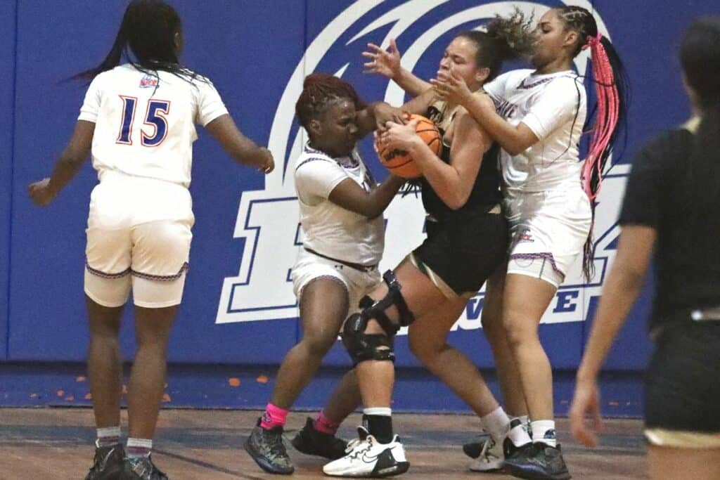P.K. Yonge's Ilaziya Wilcox battles for the ball against Trinity Catholic on Friday.