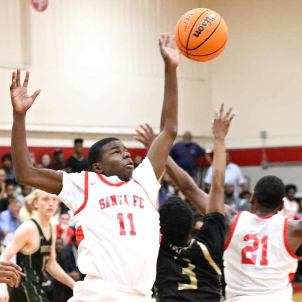 Santa Fe's Antonio Hall goes for a loose ball against The Villages in the Region 2-4A Final on Friday.