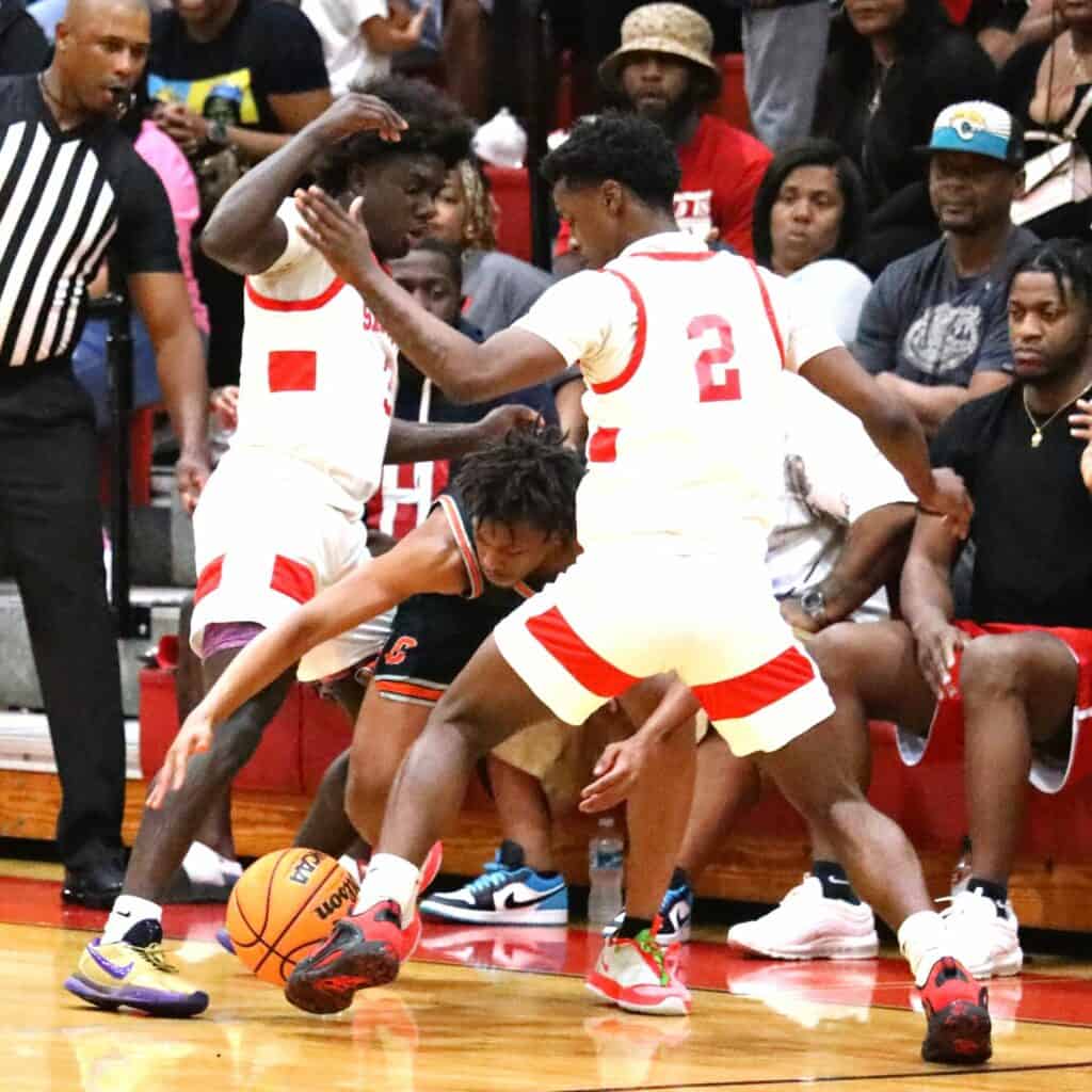 Santa Fe's Don'trell Jenkins (3) and Jamil Watson Jr. (2) force a turnover in the Region 2-4A semifinals on Tuesday.