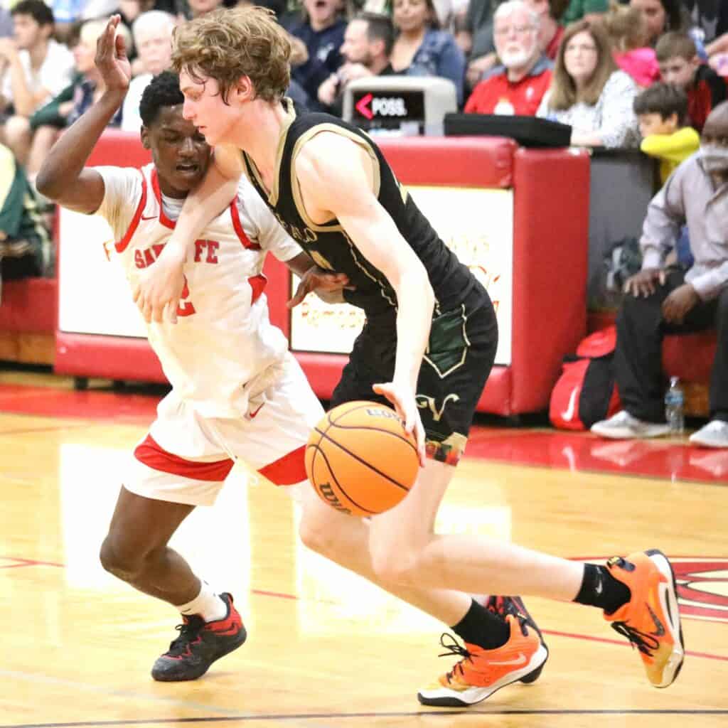 Santa Fe's Jamil Watson plays tight defense on The Village's Sam Walters in the Region 2-4A Final on Friday.