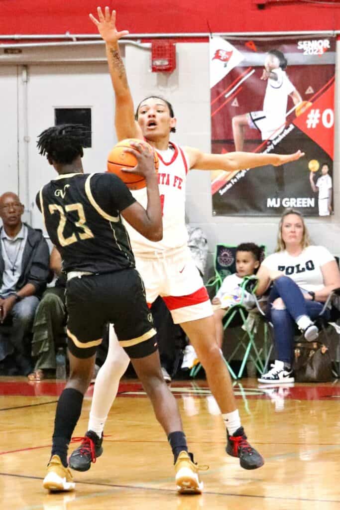 Santa Fe's Makhi Lewis with tight defense against The Villages in the Region 2-4A Final on Friday.