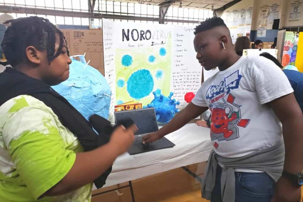 A Lincoln Middle School sixth grader presents a norovirus display at Wednesday's Germ Museum.