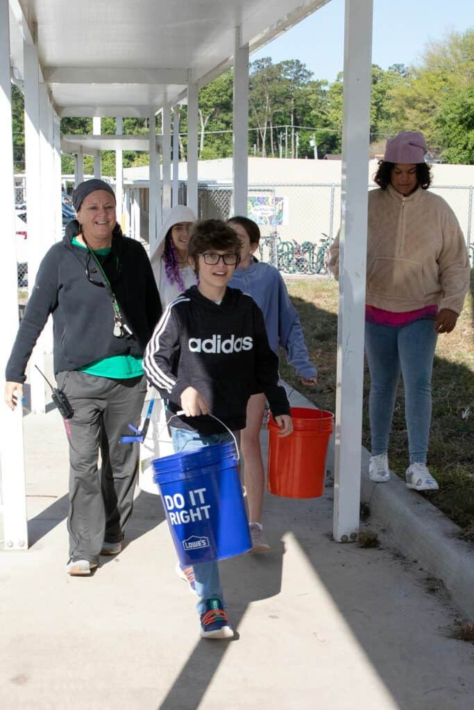 Members of the Westwood Middle School environmental club and their supervisor, physical education instructor Ginger Fuller.