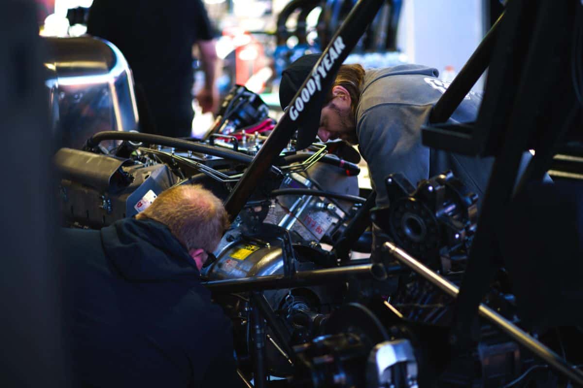 Racing team rebuilding their vehicle after a successful run at Gatornationals.