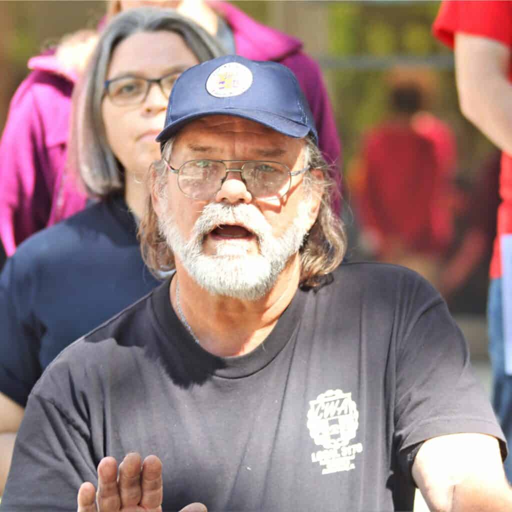 Robert Arnold, president of CWA 3170, speaks against the proposed bill on the steps of City Hall.