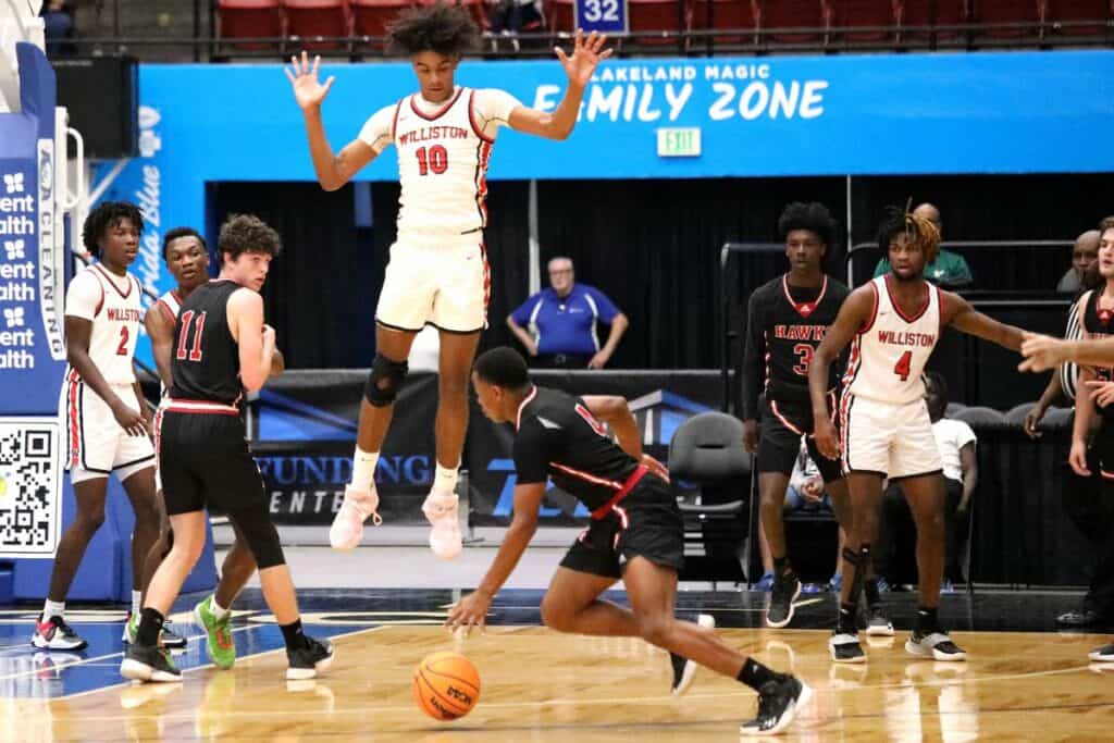 Williston's Kyler Lamb (10) and the Red Devils look to leap into the school's record books with its first boys basketball state championship on Friday.