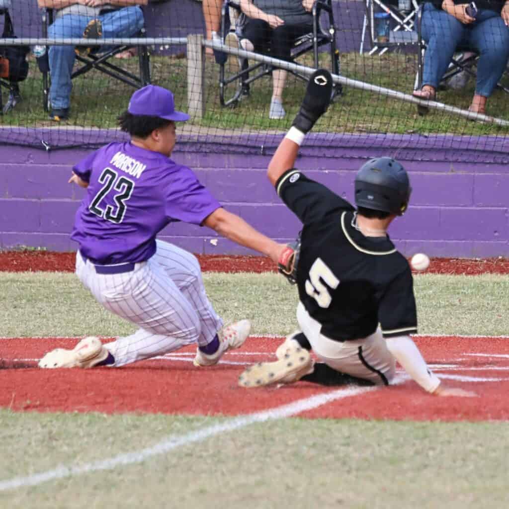 Buchholz's J.J. Gardner scores on a passed ball as Gainesville pitcher Josh Morison tries to get the tag in the third inning.