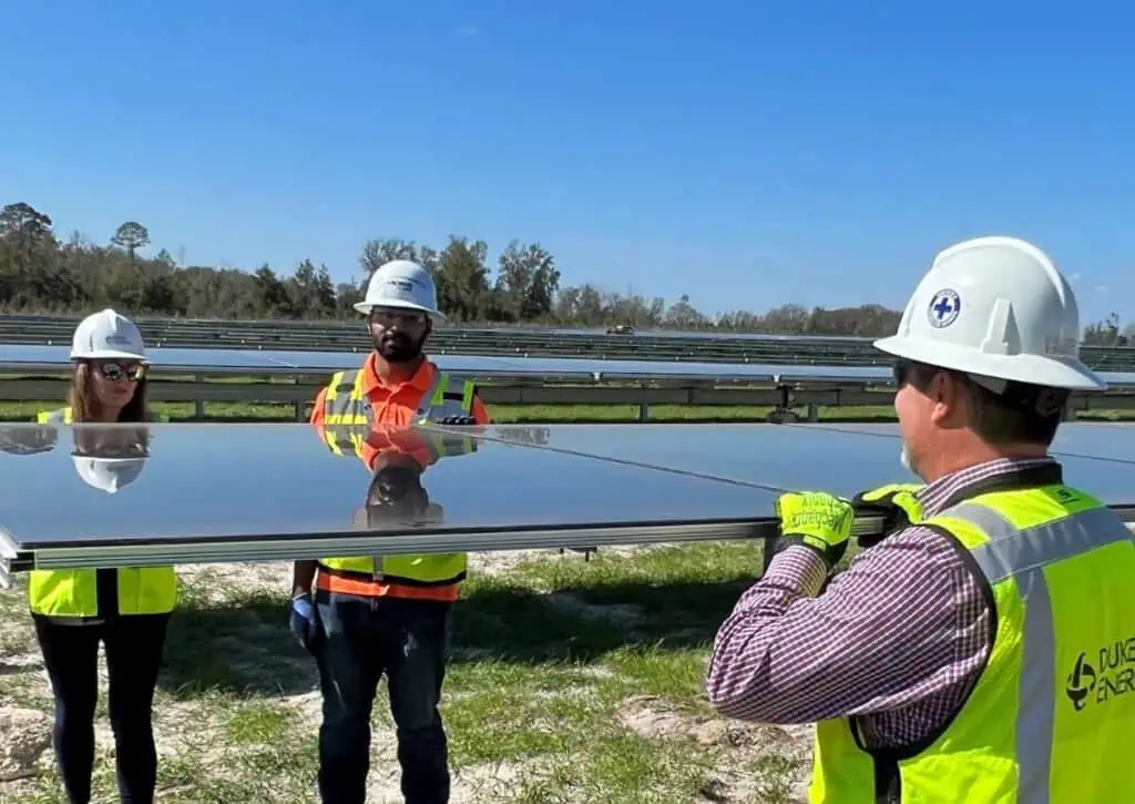 Duke Energy workers install the last panel at High Springs.