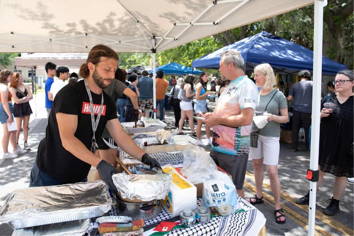Vendor Majd Afaghani prepares his booth, which offered a variety of Palestinian food.