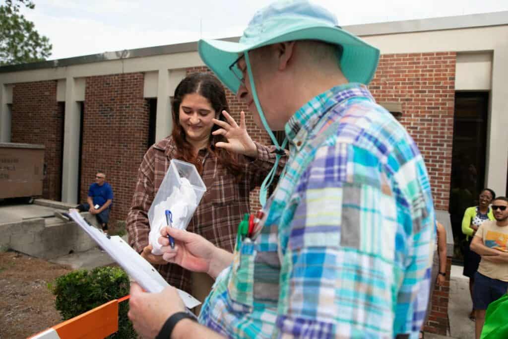 A disgusted Heba Alzaatari examines the gooey remains of her shattered egg inside a broken plastic container. “I hate eggs,” the 10th grader said.
