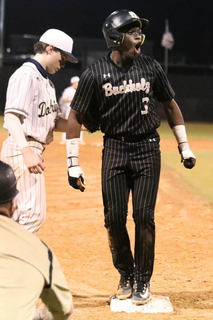 Buchholz's Cedaris Smith celebrates his two-run third inning triple that gave the Bobcats' a 5-0 lead against Gulf Breeze on Wednesday.