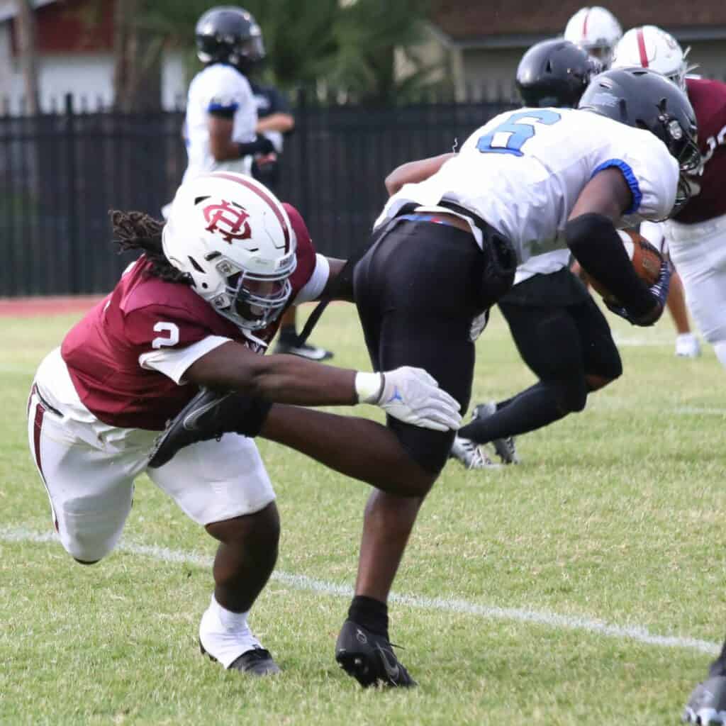 Oak Hall's Abram Jerkins (2) knifes through the line for a tackle against Impact Christian on Thursday.