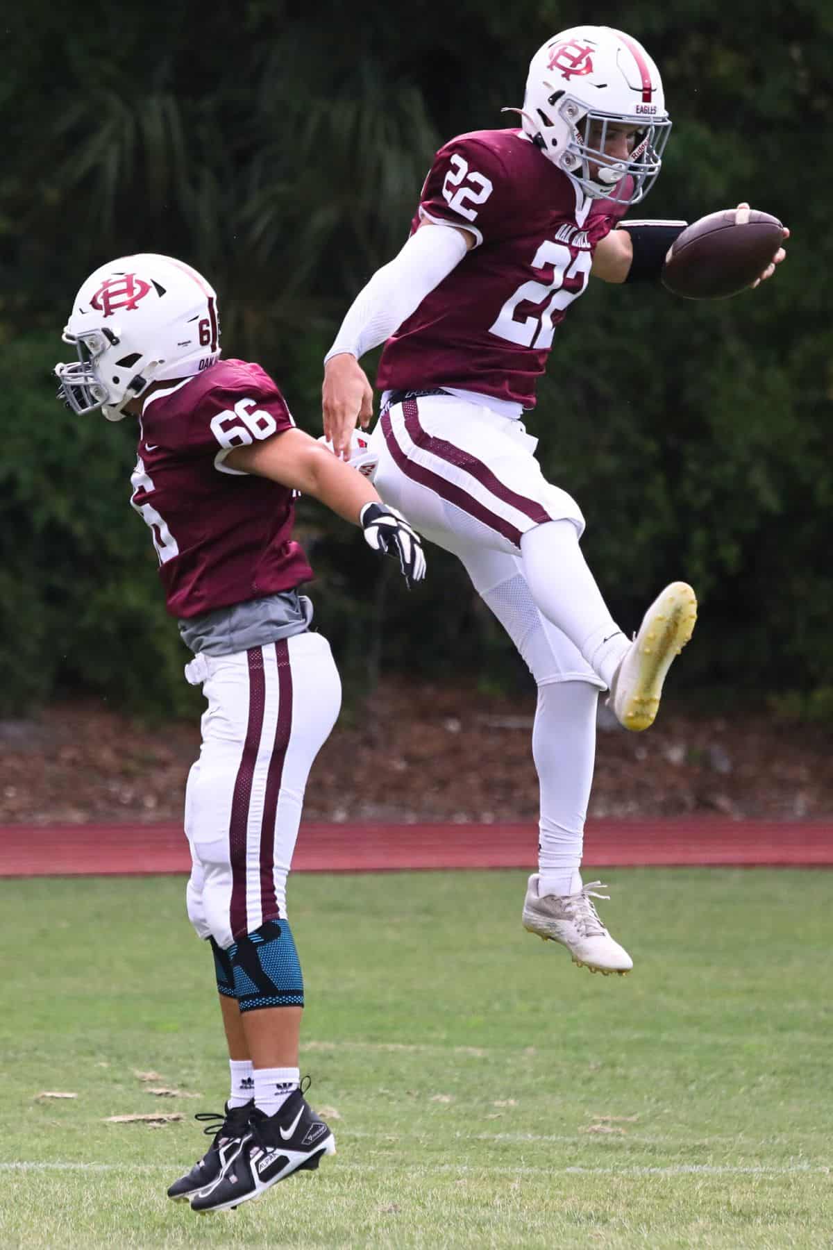 Oak Hall's Carter Dykes (22) celebrates with Josh Turner (66) following Dykes' touchdown run against Impact Christian on Thursday. Oak Hall's Carter Dykes (22) celebrates with Josh Turner (66) following Dykes' touchdown run against Impact Christian on Thursday.