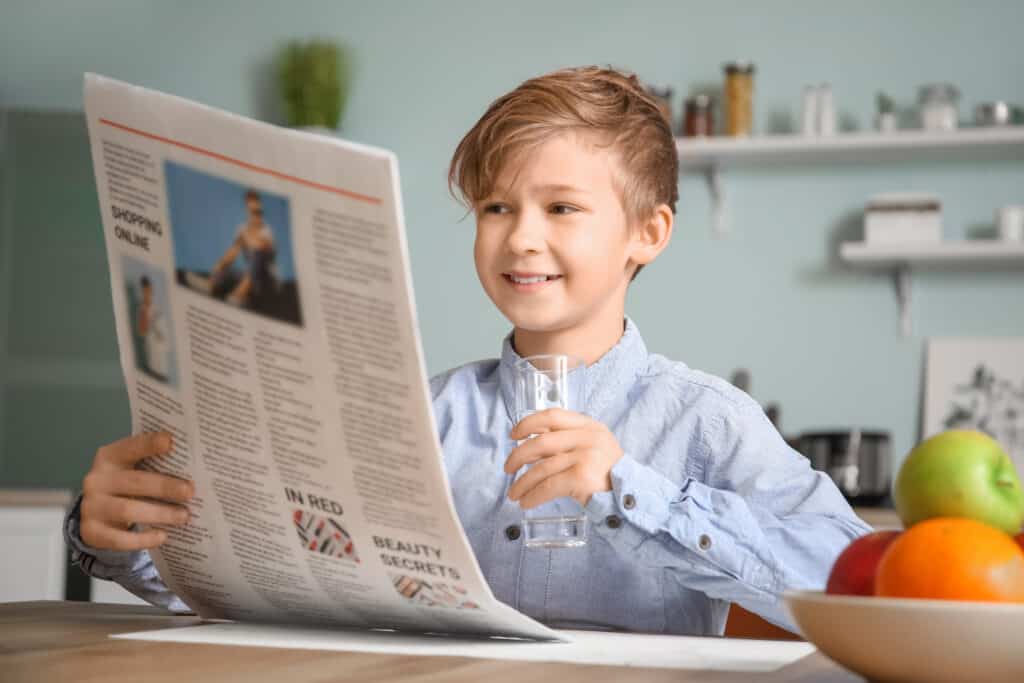 Boy reading paper