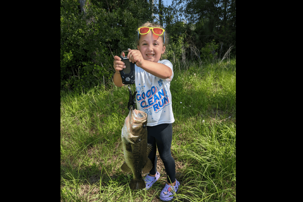 Emerson Fair, age 6, shows off her 4-pound bass.