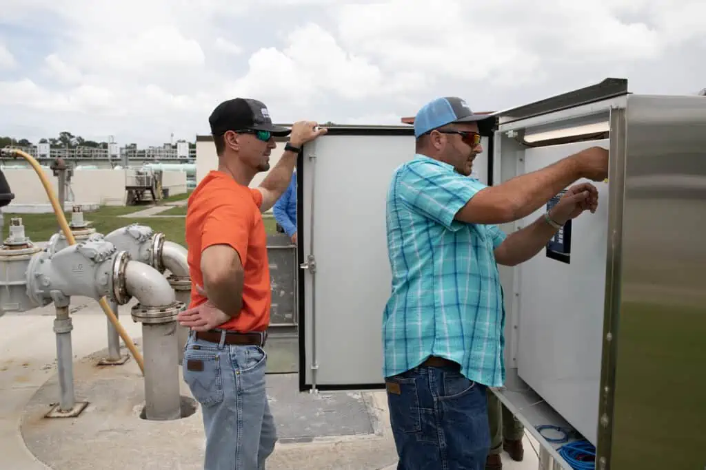 Kanapaha Water Reclamation Facility Supervisor Dusty Griffis, left, and Lift Stations Supervisor Levi Lee, right, work the control panel for a lift station located at the Kanapaha facility. 