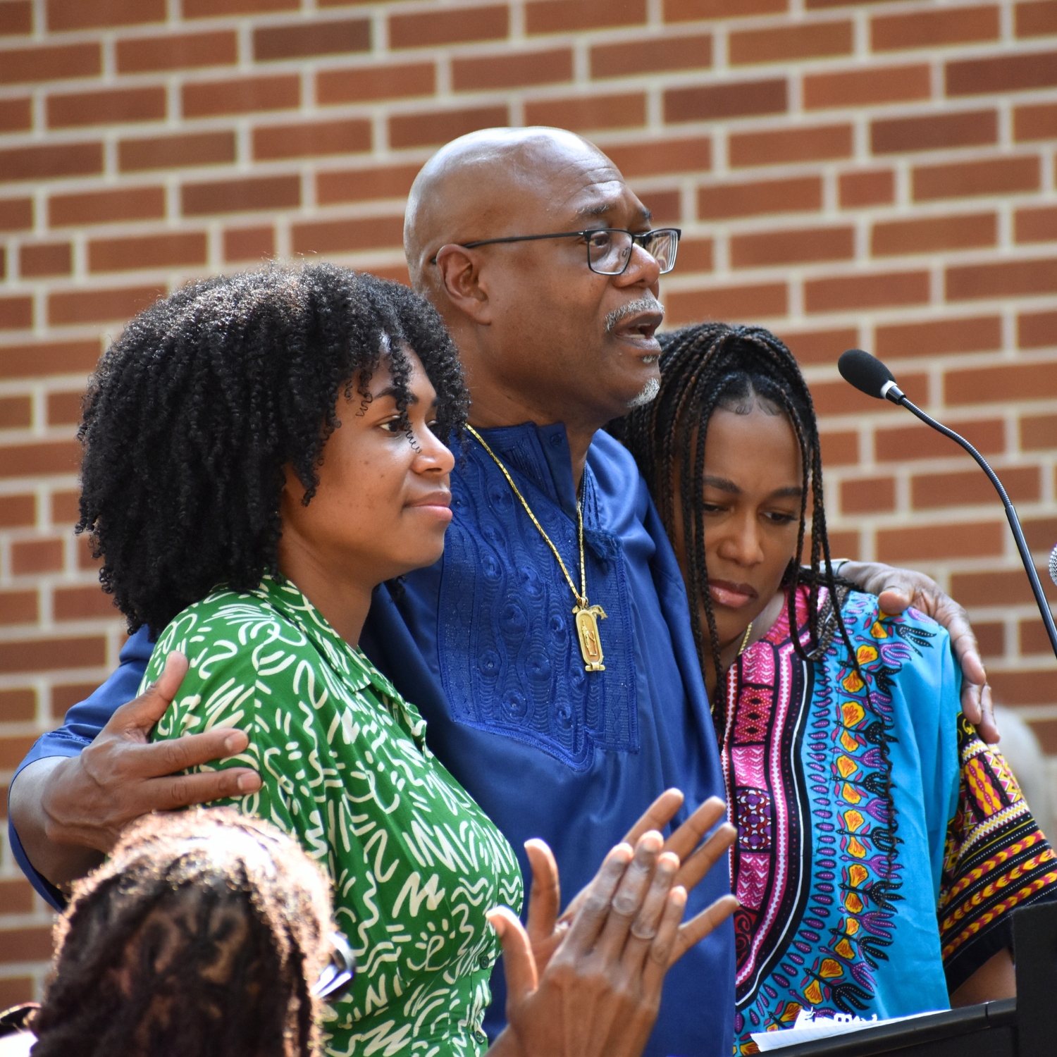 Kenneth Nunn holds his and Patricia Hilliard-Nunn's daughters Foluke (in green) and Dayo (in blue).