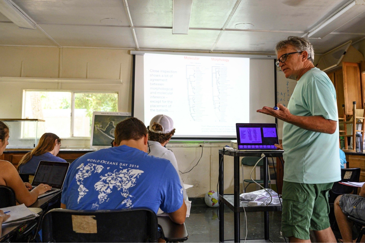 Gavin Naylor (right) gives a lecture to students on shark phylogenetics and evolution.