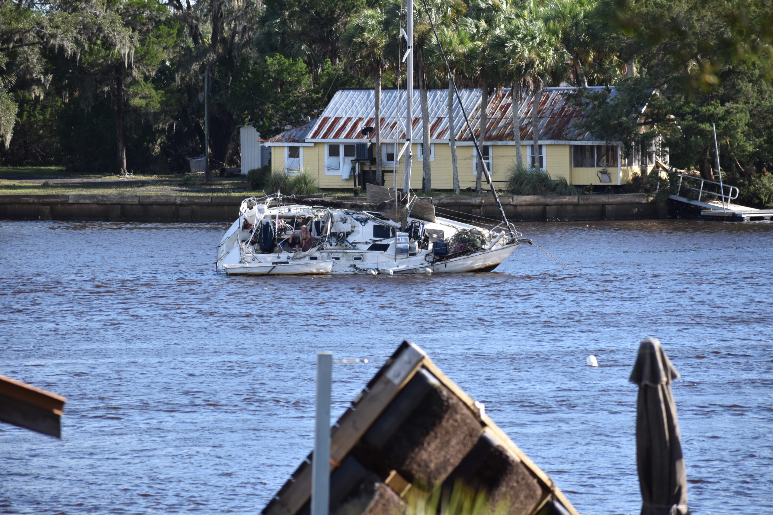 A man sits on an overturned boat in Steinhatchee on Wednesday. Cred Glory A man sits on an overturned boat in Steinhatchee on Wednesday.