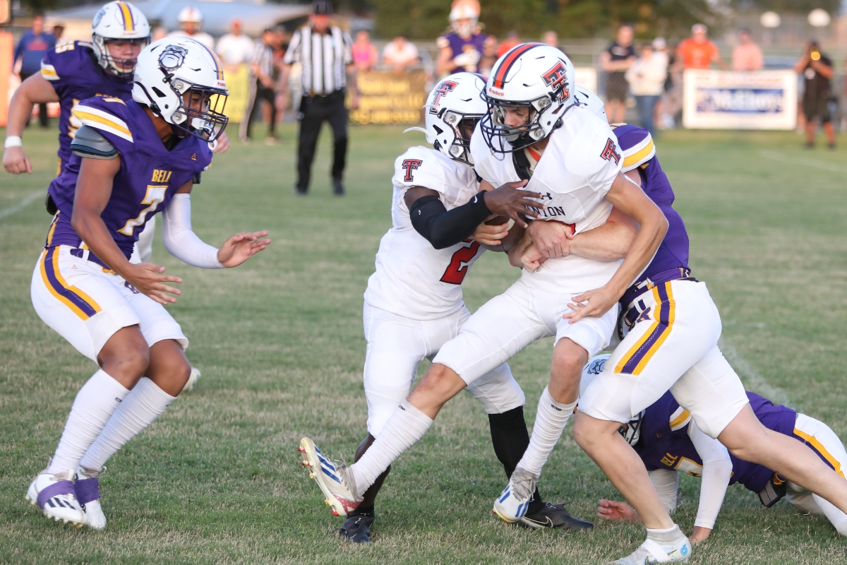 Bell's Cole Rarey with a tackle on Trenton's Alex Norman in the Tigers' 28-0 road win on Thursday.