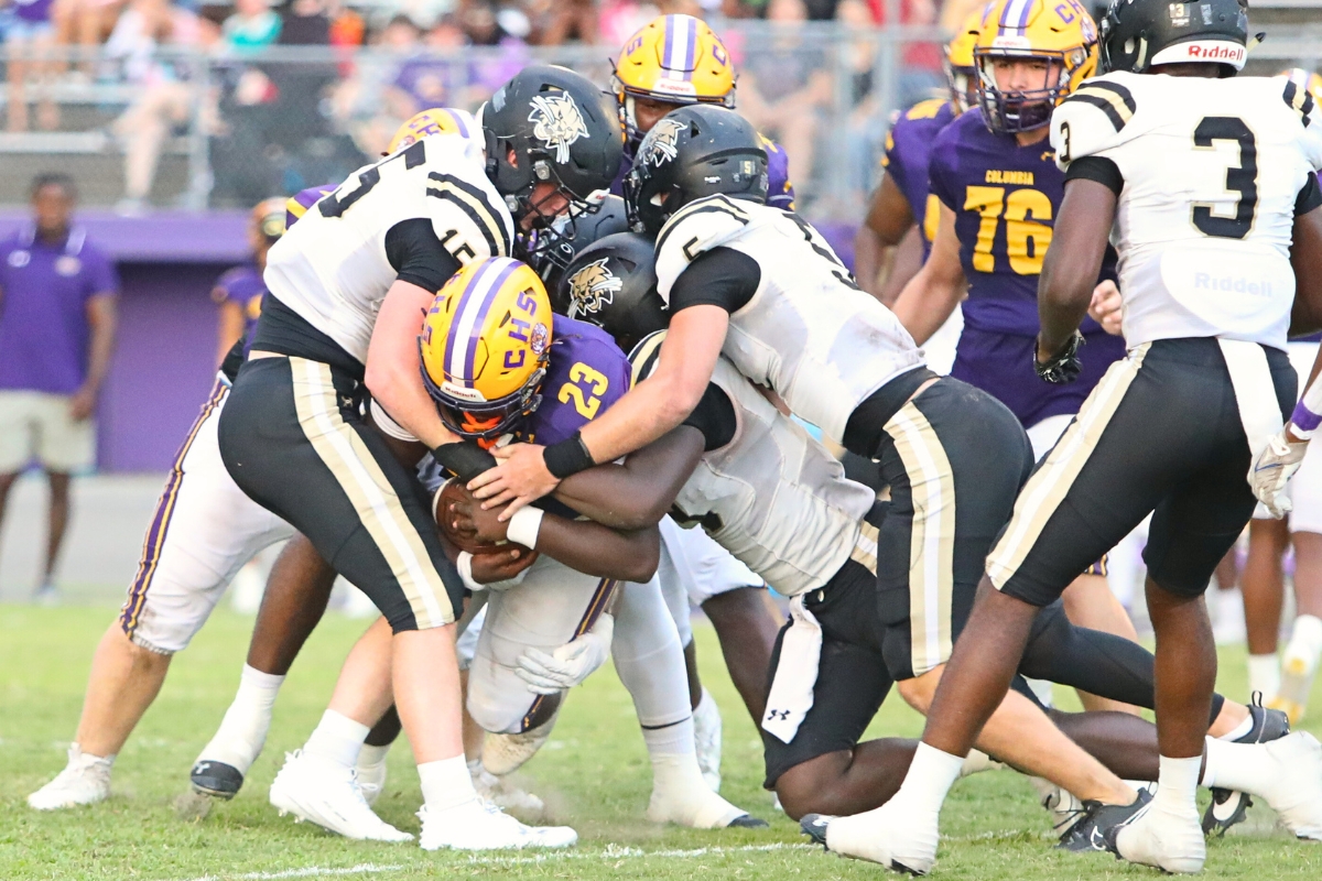 Buchholz defenders swarm Columbia's Jonathan Andrews in the opening quarter of Friday's game.