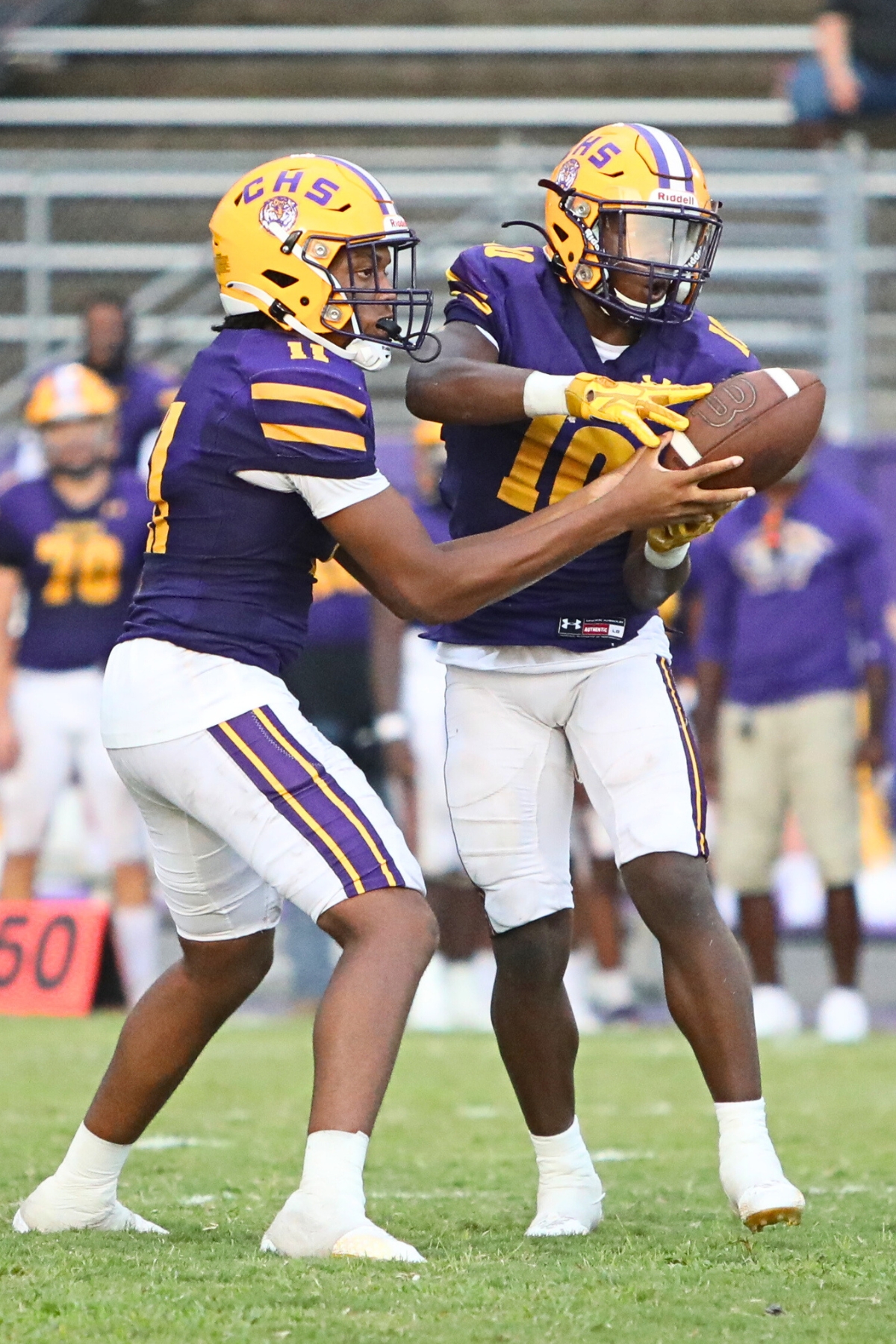 Columbia's Zach Paulk (left) hands off to Zamarion Jones in the first quarter against Buchholz on Friday.