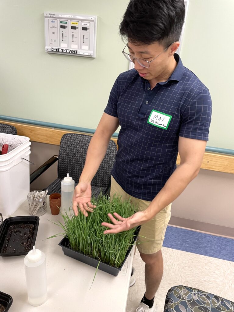 Max Ng demonstrates the therapeutic nature of gardening at a hands-on table.