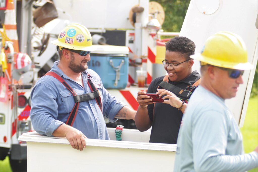 Mathias Farfan takes a ride in a bucket truck operated by GRU employees.