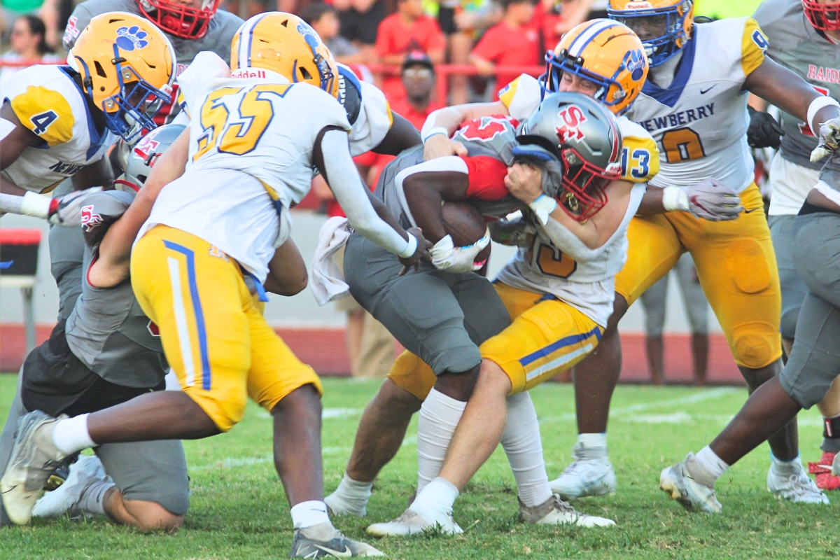 Newberry's Wyatt Hester brings down Santa Fe's Keimarion Neal in the Panthers' 68-10 win on Friday.