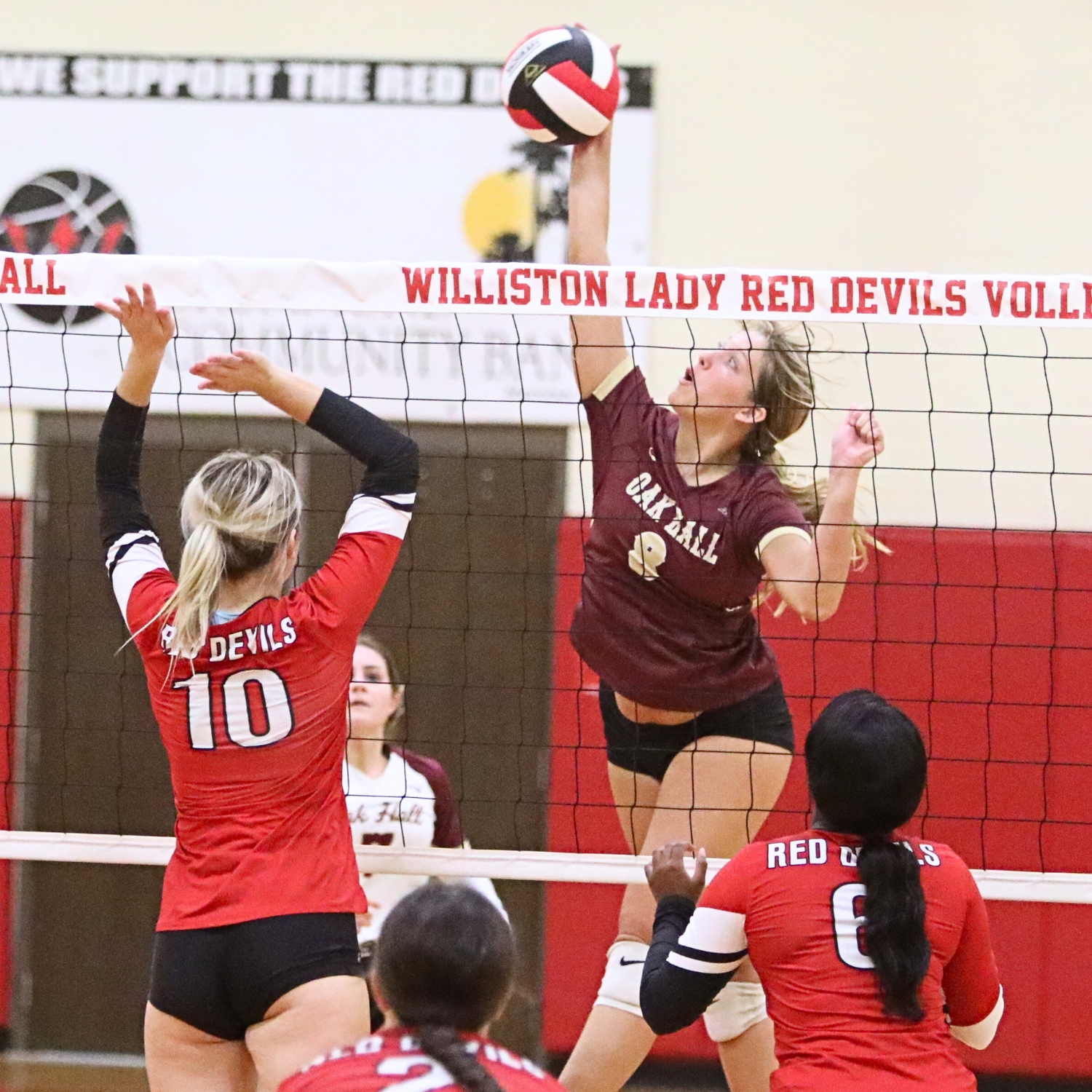 Oak Hall's Ave Scorpio (8) with a hit against Williston's Saige Bullock (10) on Tuesday.