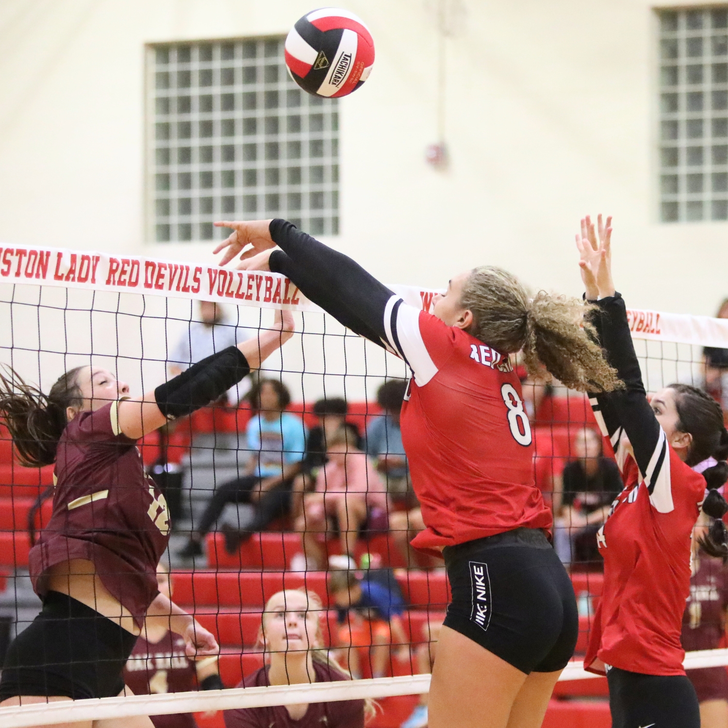 Oak Hall's Cassidy McDonald with a hit against Williston's Grace Dola (8) and Kendylle Bishop (14) on Tuesday.