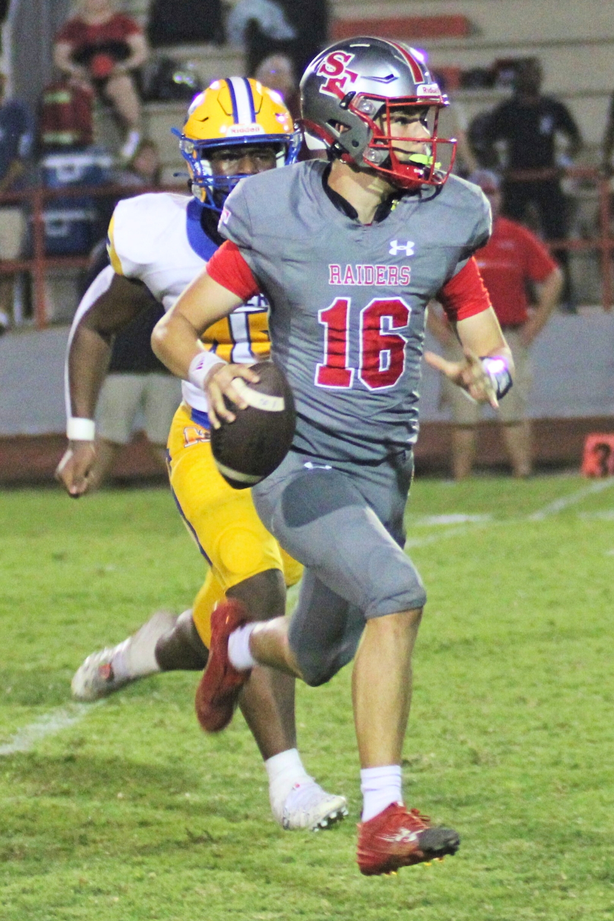 Santa Fe quarterback Tison Thomas scrambles from Newberry defenders in a 68-10 home loss on Friday.