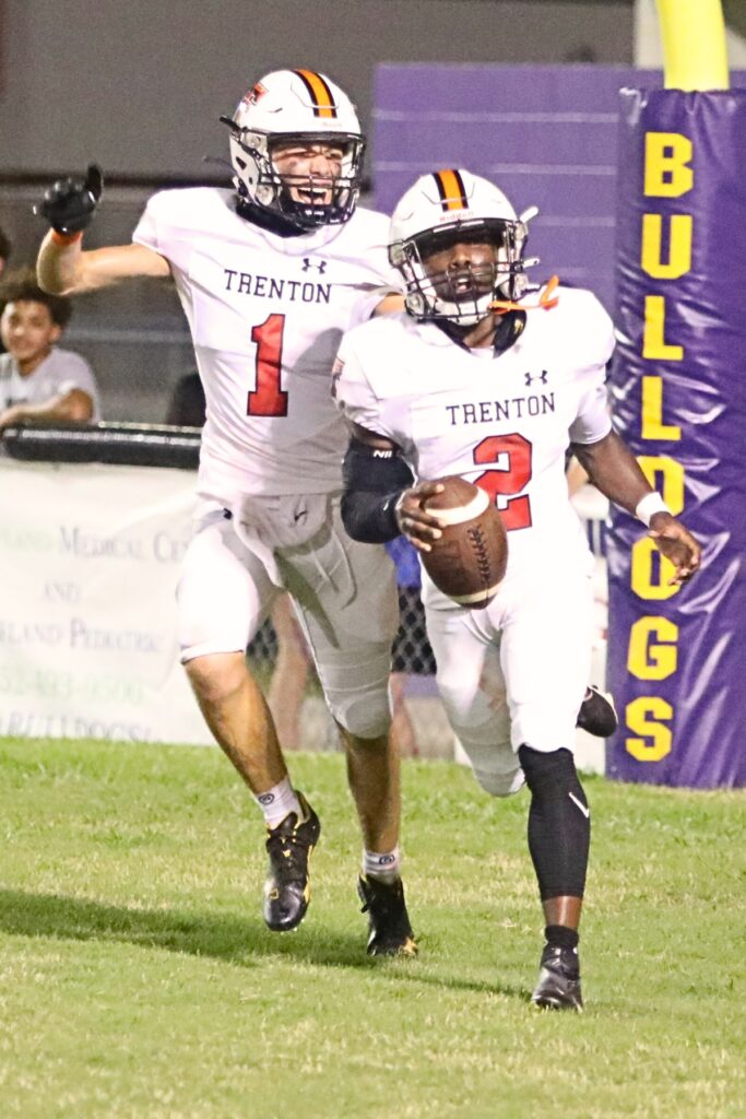 Trenton's Landen Gibbs (1) celebrates J'dyen Manneh's (2) third touchdown in the second quarter in a 28-0 win at Bell on Thursday.