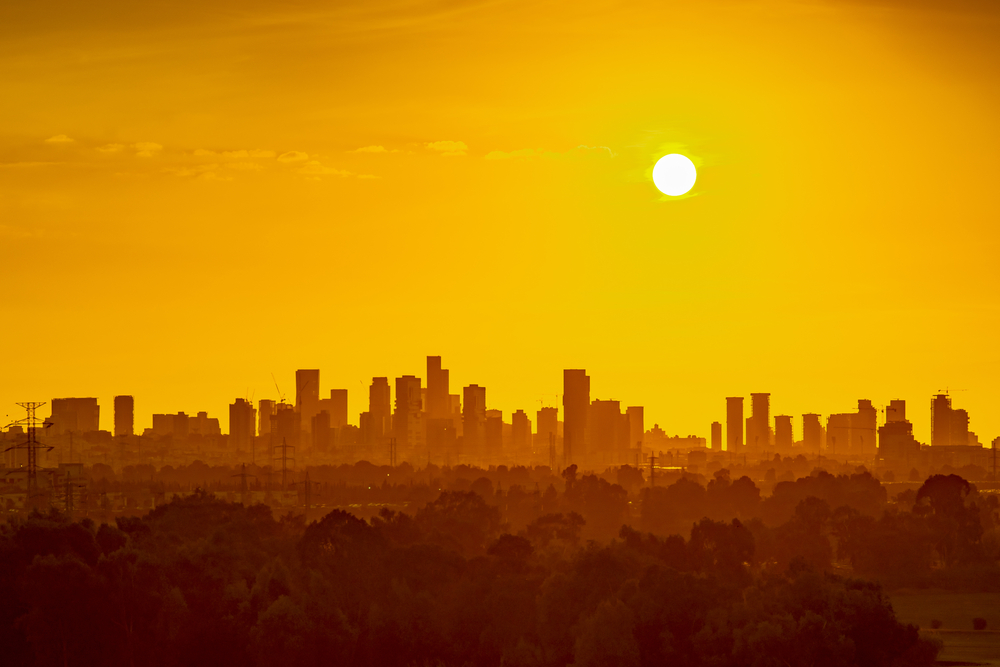 Sun over city skyline heat wave