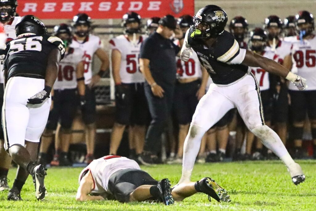 Buchholz's Kendall Jackson (8) celebrates after a first quarter sack against Creekside on Friday.
