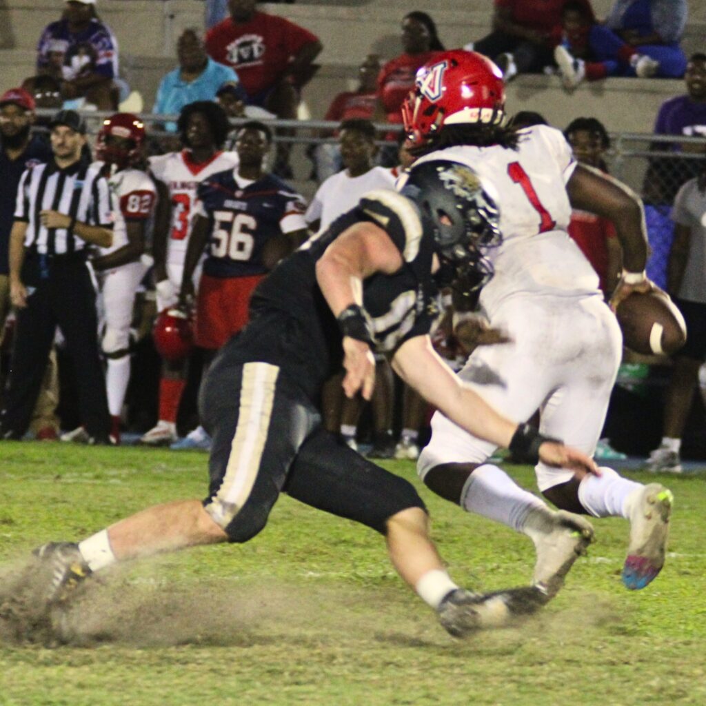 Buchholz's Thomas Weinhardt pressures the Vanguard quarterback on Friday.