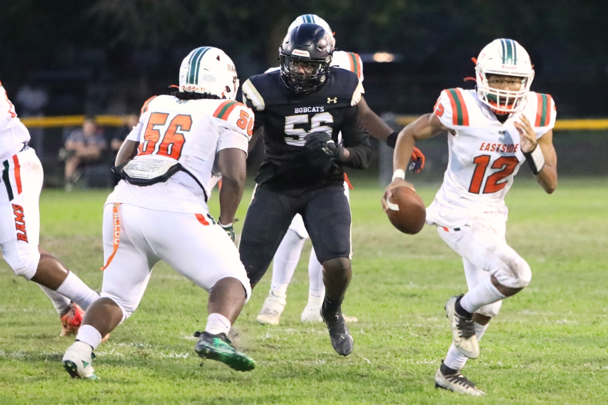 Eastside's Adrian Curtis with a first quarter scramble against Buchholz on Friday.