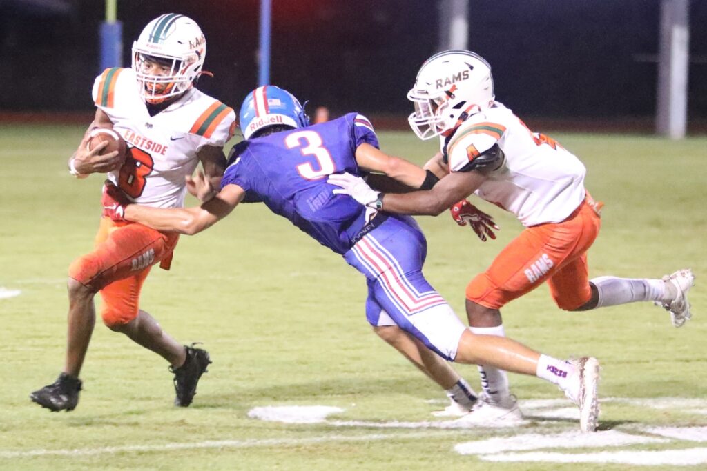 Eastside's Joshua Benjamin (8) runs through an attempted tackle by Keystone Heights' Wyatt VanZant (3) on Friday.