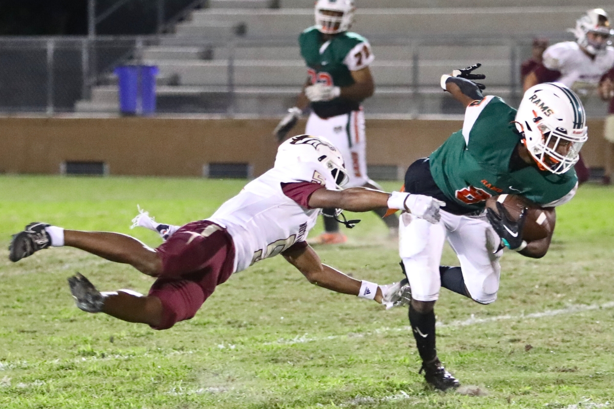 Eastside's Joshua Benjamin breaks a tackle against North Marion on Thursday.