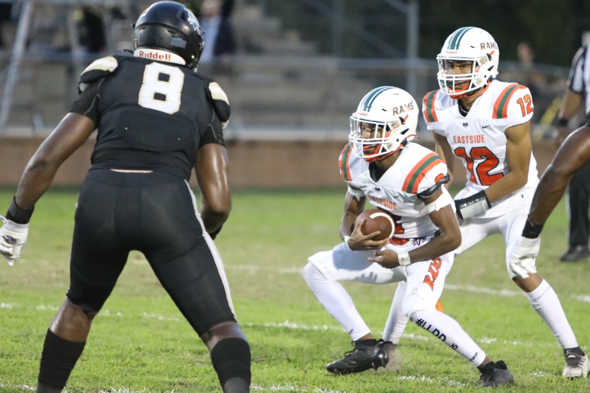 Eastside's Joshua Benjamin takes a first quarter handoff against Buchholz on Friday.
