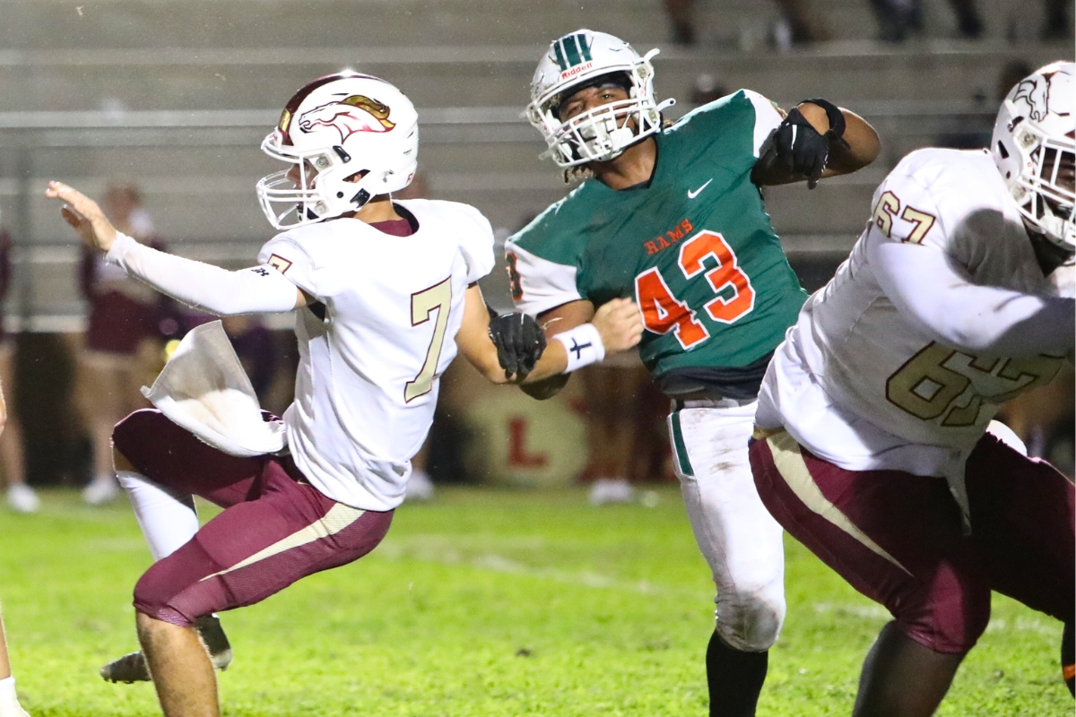 Eastside's Travis Curtis pressures North Marion's quarterback in the second quarter on Thursday.