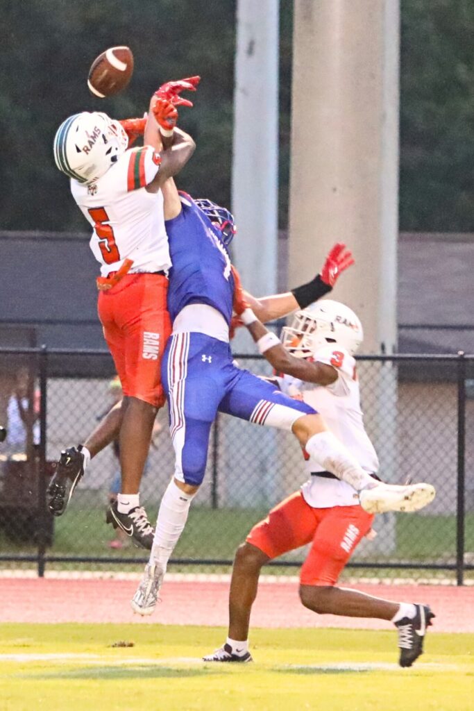 Eastside's Victor White (5) and Thomas Young III (3) break up a pass intended for Keystone Height's Garrison Teague on Friday