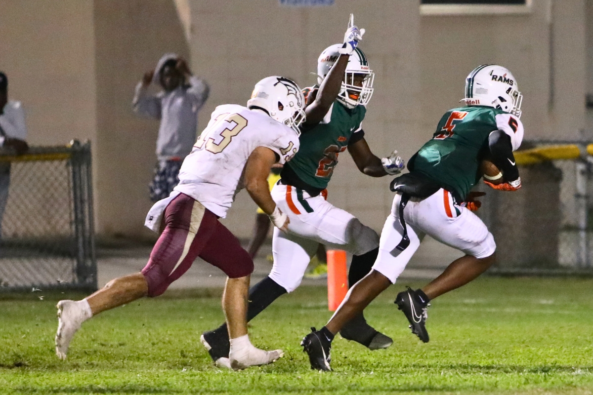Eastside's Victor White (5) scoops up a second quarter blocked punt and returns it for a touchdown against North Marion on Thursday.