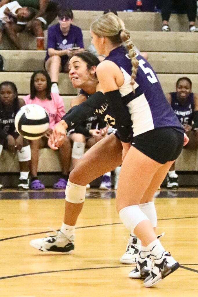 Gainesville's Brooklyn Tealer (left) and Madison Howard go for a dig against Vanguard on Tuesday.